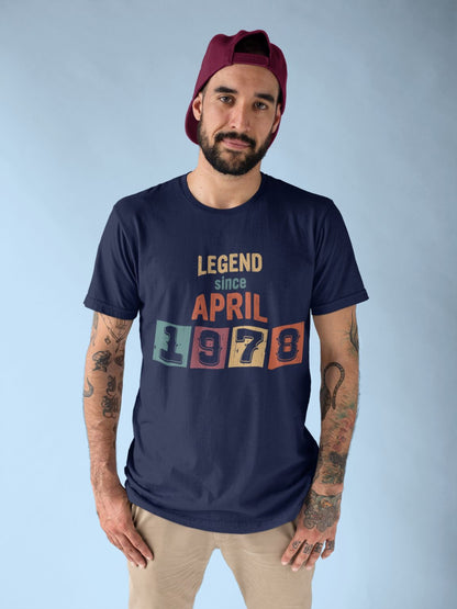 A man wearing a maroon baseball cap and a navy blue t-shirt with the text "LEGEND since APRIL 1978" printed on it.