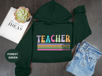 a green hoodie with the words teacher on it