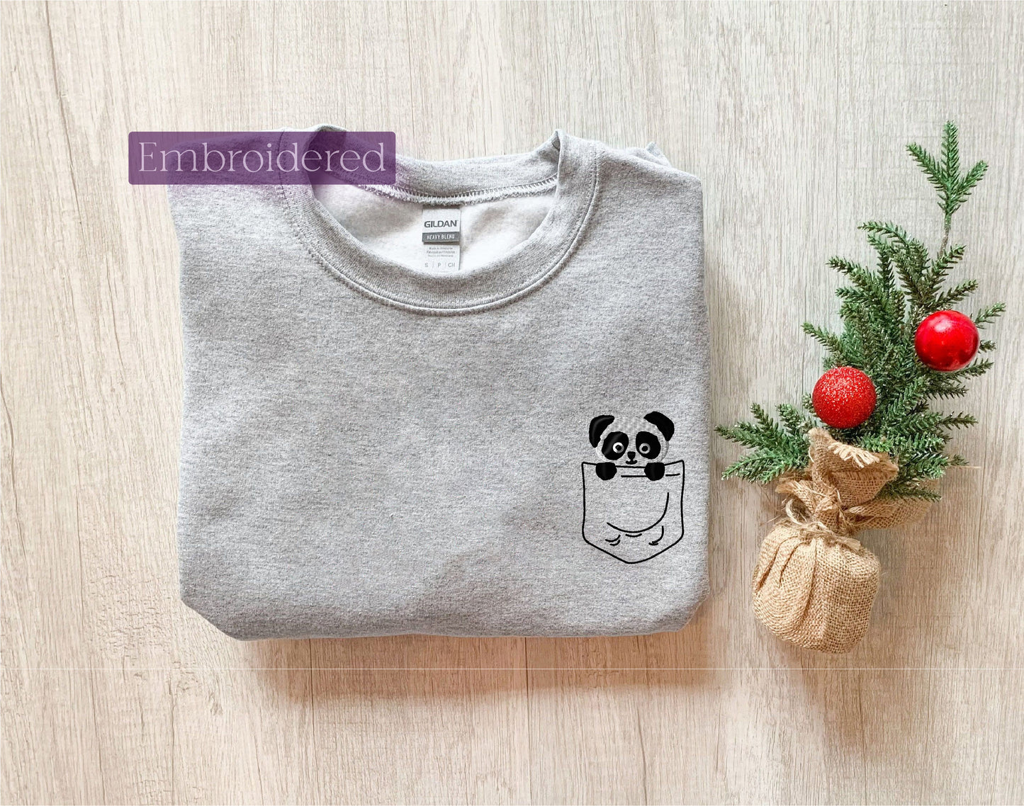 a t - shirt with a face drawn on it next to a christmas tree