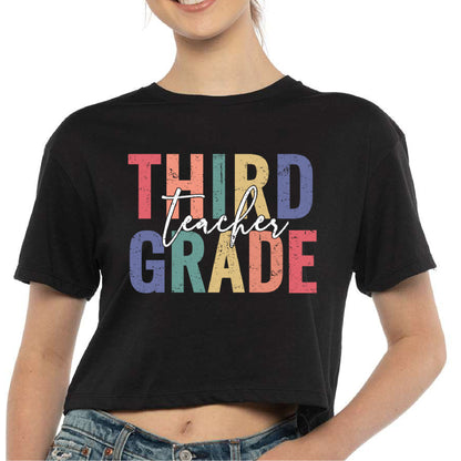 a woman wearing a black shirt that says third grade