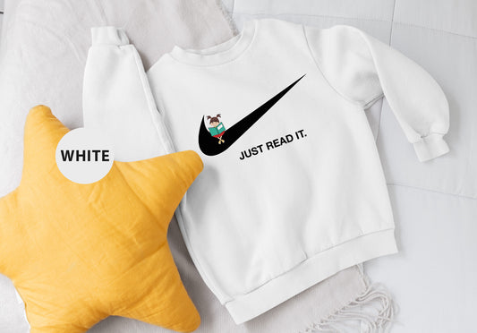 a white sweatshirt and a yellow star on a bed