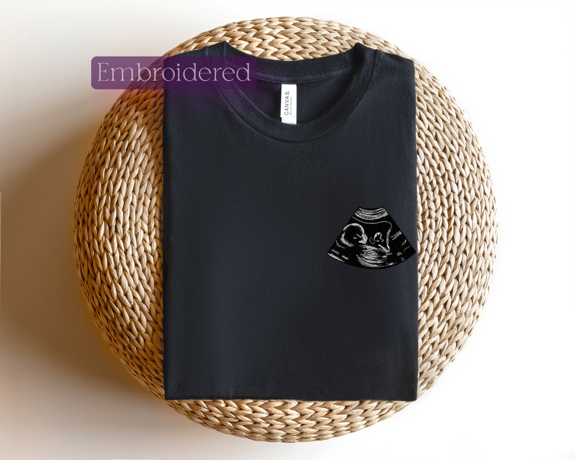 a black t - shirt with a cat on the front