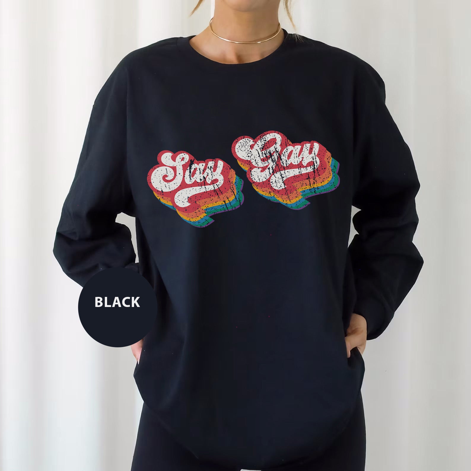 a woman wearing a black sweatshirt with a pair of hearts on it