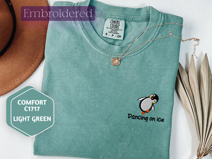 a green shirt with a penguin on it