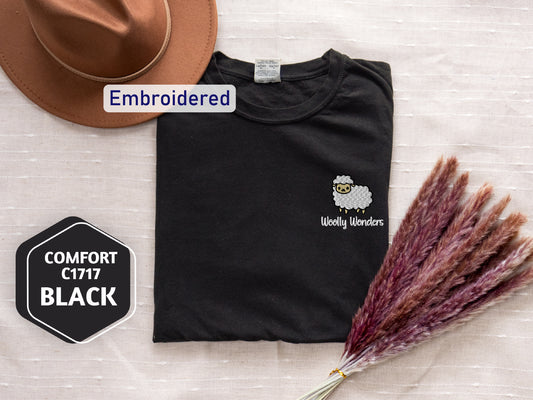 a hat, t - shirt, and dried grass on a table