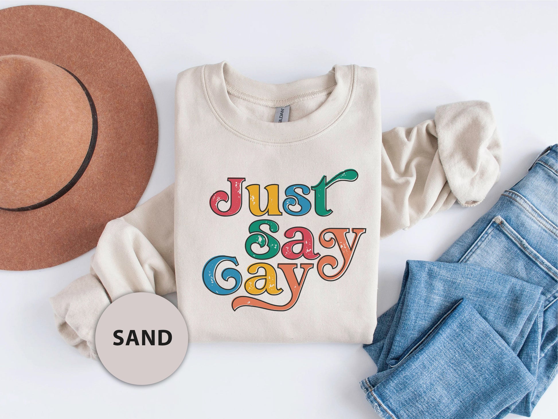 a t - shirt that says just say gay next to a hat and jeans