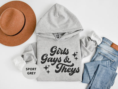 a hoodie, jeans, and hat are laid out on a white surface