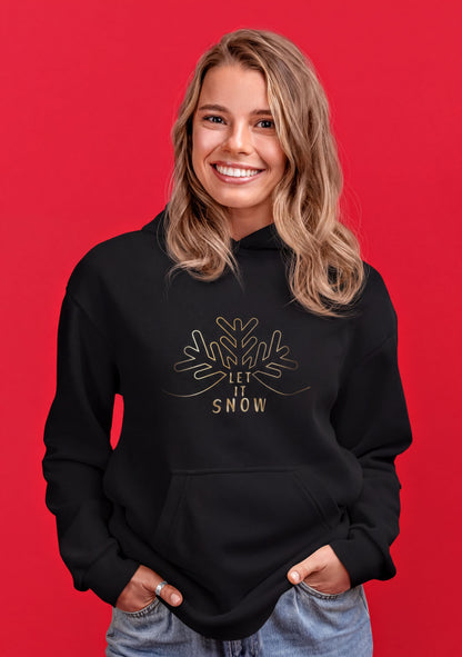 A smiling woman wearing a black hoodie with a snowflake design and the text "LET IT SNOW" printed on it.