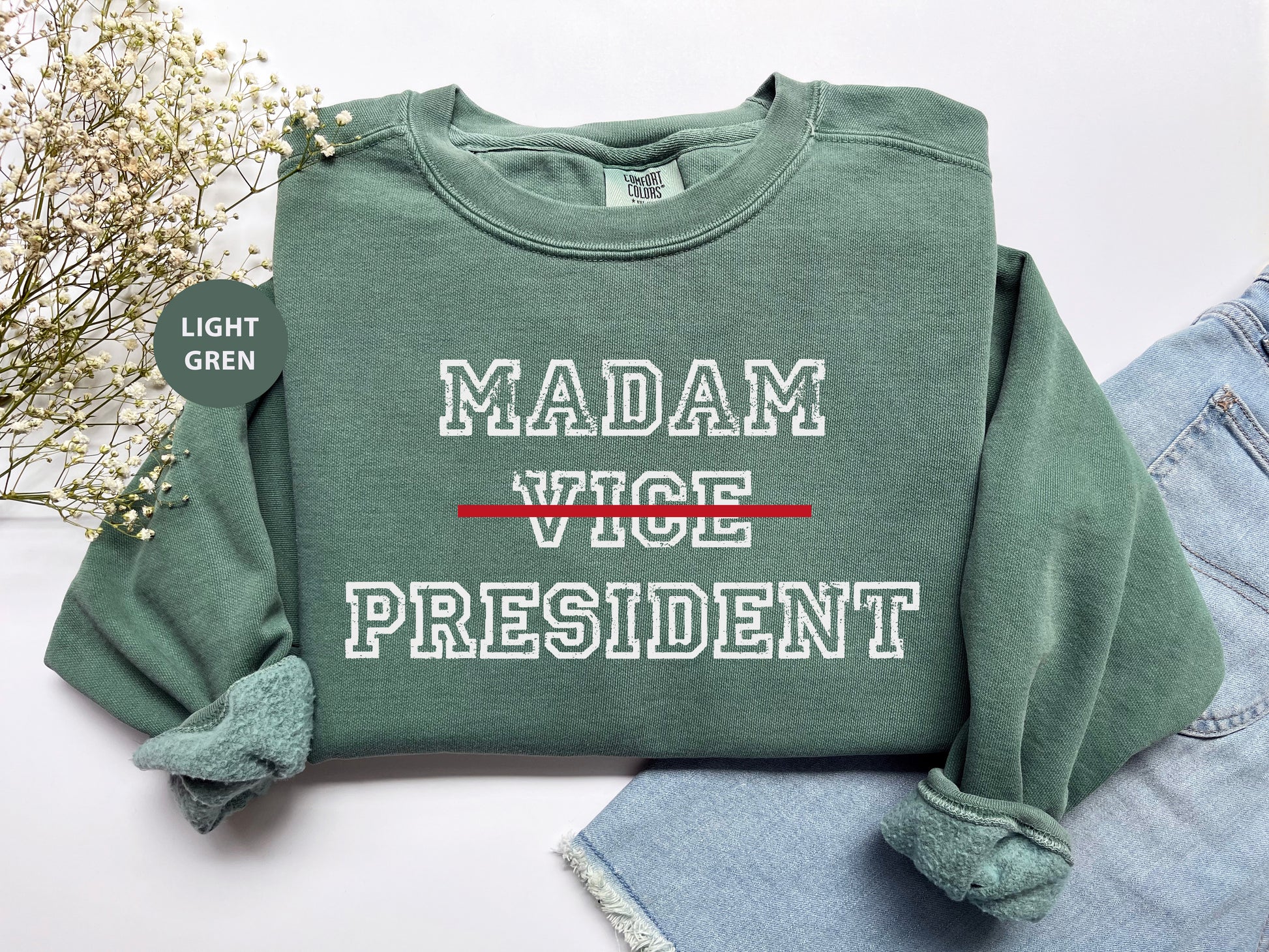 a green sweatshirt with the words madam vice president printed on it