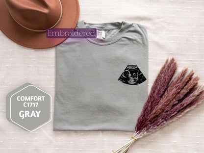 a hat and a t - shirt with a picture of a cat on it