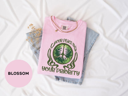 a pink shirt with a green tree on it