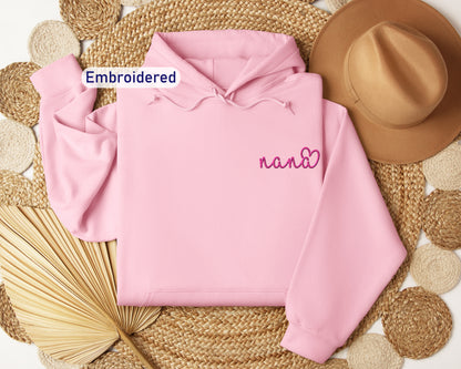 a pink hoodie with embroidered name on it