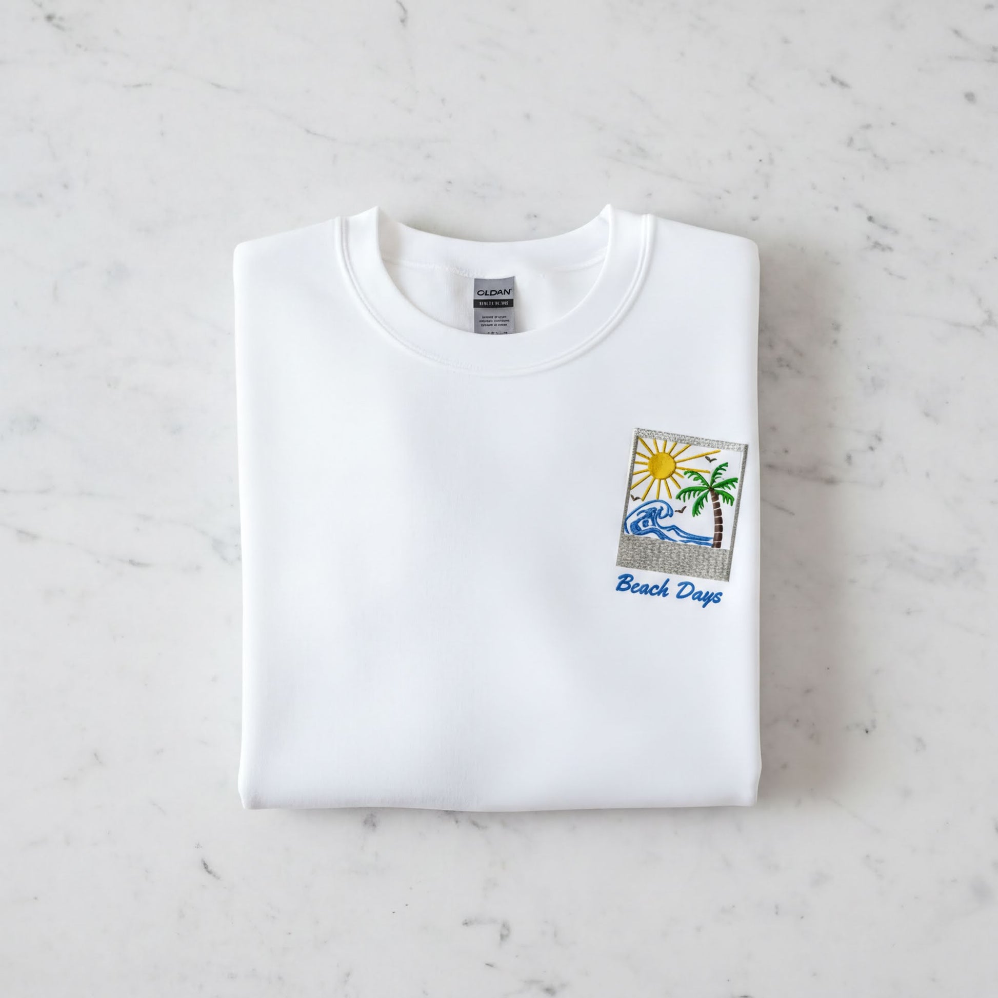A white t-shirt with a beach-themed design and the text "Beach Days" printed on it.
