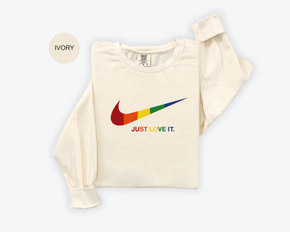 a white shirt with a rainbow nike logo on it