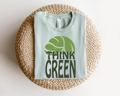 a t - shirt that says think green on it