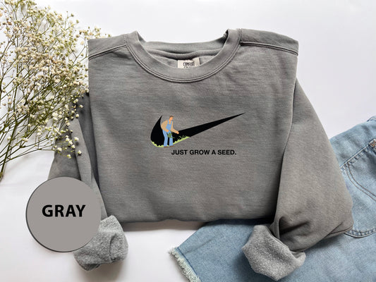 a gray sweatshirt with a graphic of a bird on it