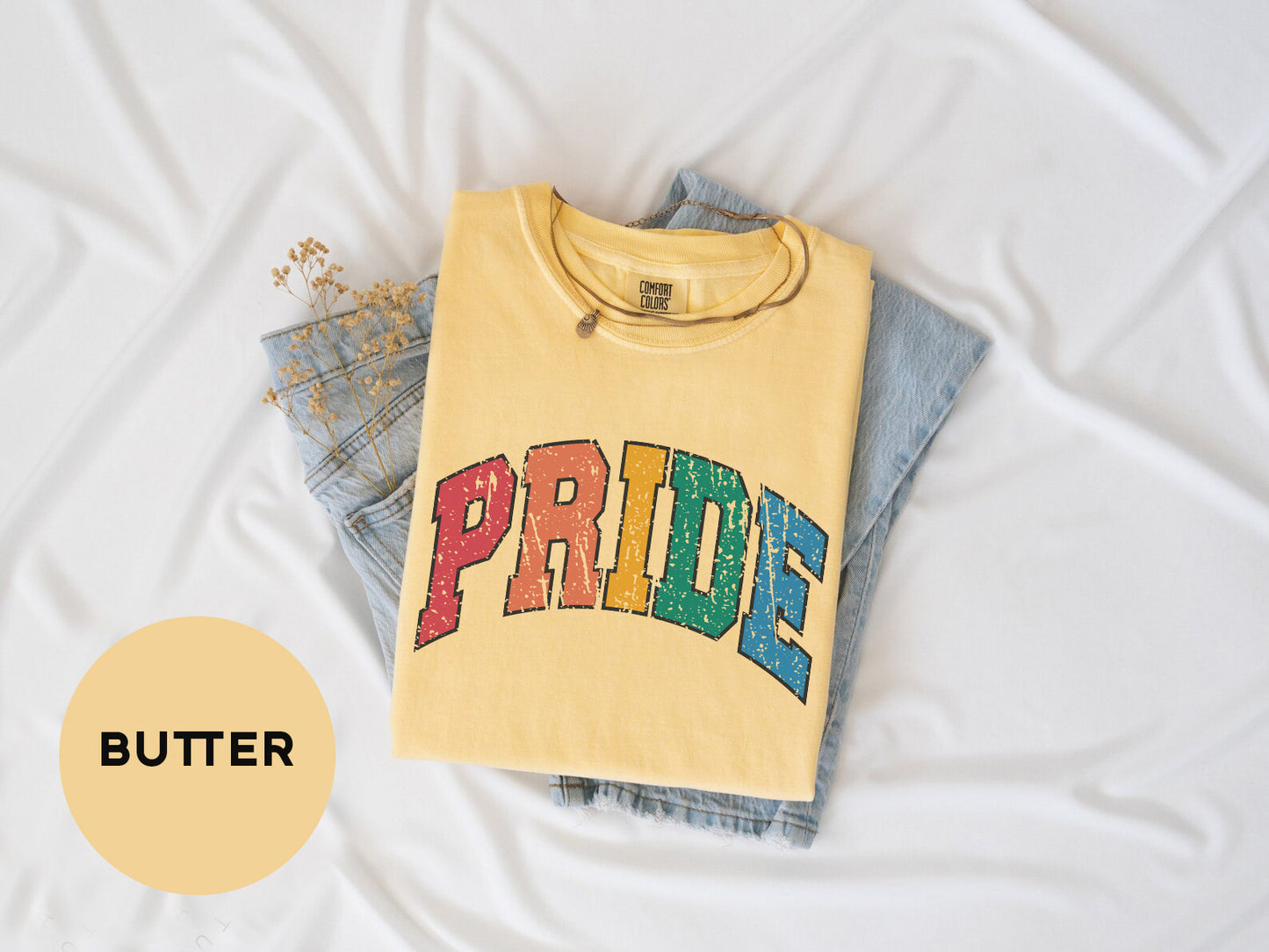 a yellow shirt with the word pride on it