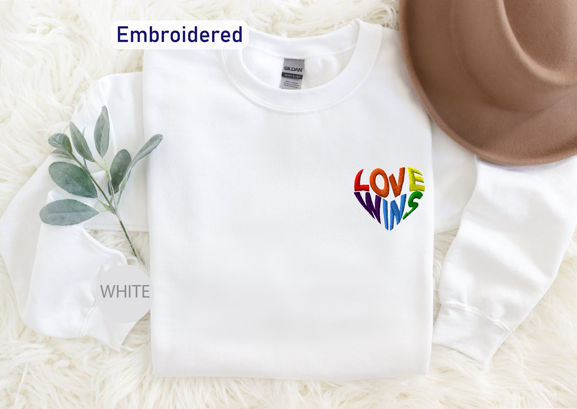 a white sweater with a colorful heart on it