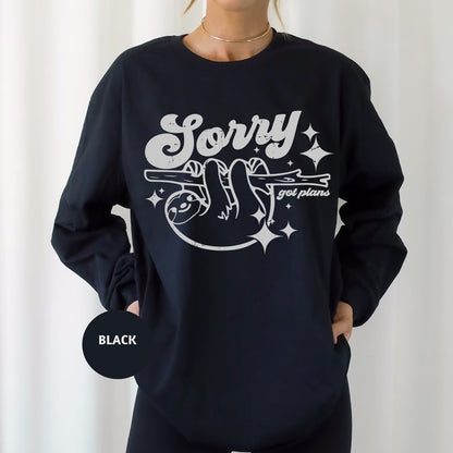 a woman wearing a black sweatshirt that says sorry and smiling