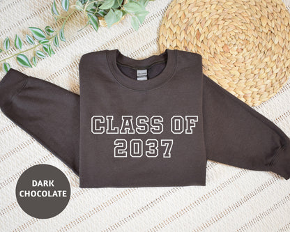 a black shirt that says class of 2017 next to a straw hat