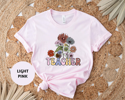 a t - shirt that says teacher with flowers on it