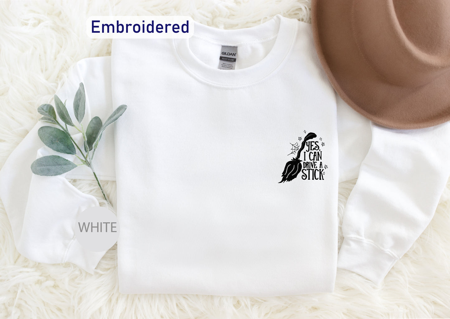 a white sweatshirt with a black bird embroidered on it