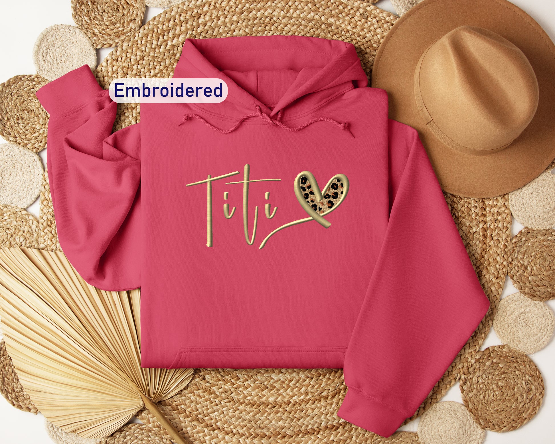 a pink hoodie with a heart and two hearts on it