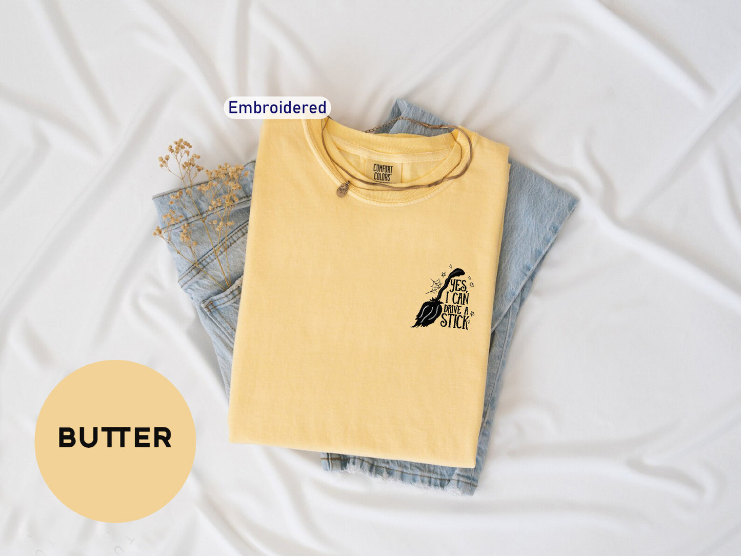 a yellow shirt with a black bird on it