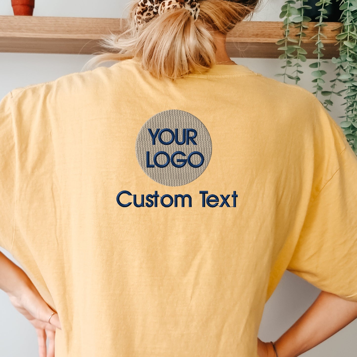 a woman wearing a yellow t - shirt with a leopard print on the back