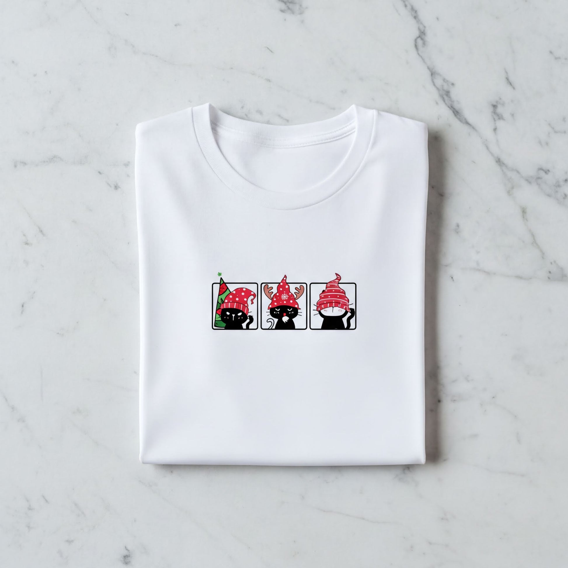 A white t-shirt with a graphic design featuring three cartoon cats wearing red hats.