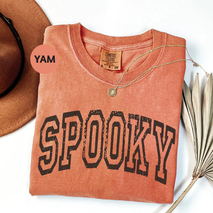 a shirt that says spooky on it next to a hat