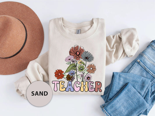 a t - shirt that says teacher with flowers on it