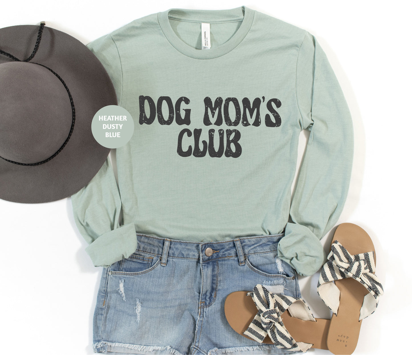 a shirt that says dog mom's club next to a hat and sandals