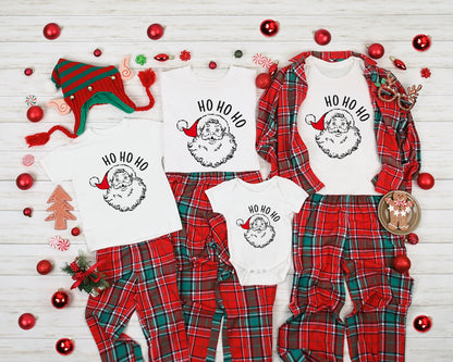A collection of Christmas-themed items, including pajamas, a Santa Claus hat, and ornaments, arranged on a white background.