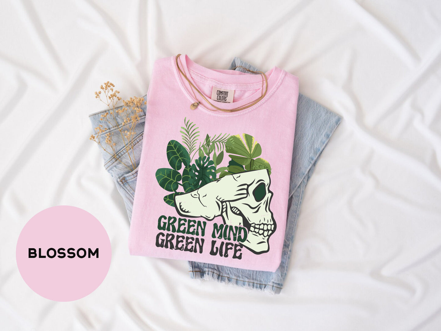 a pink shirt with a green mind on it