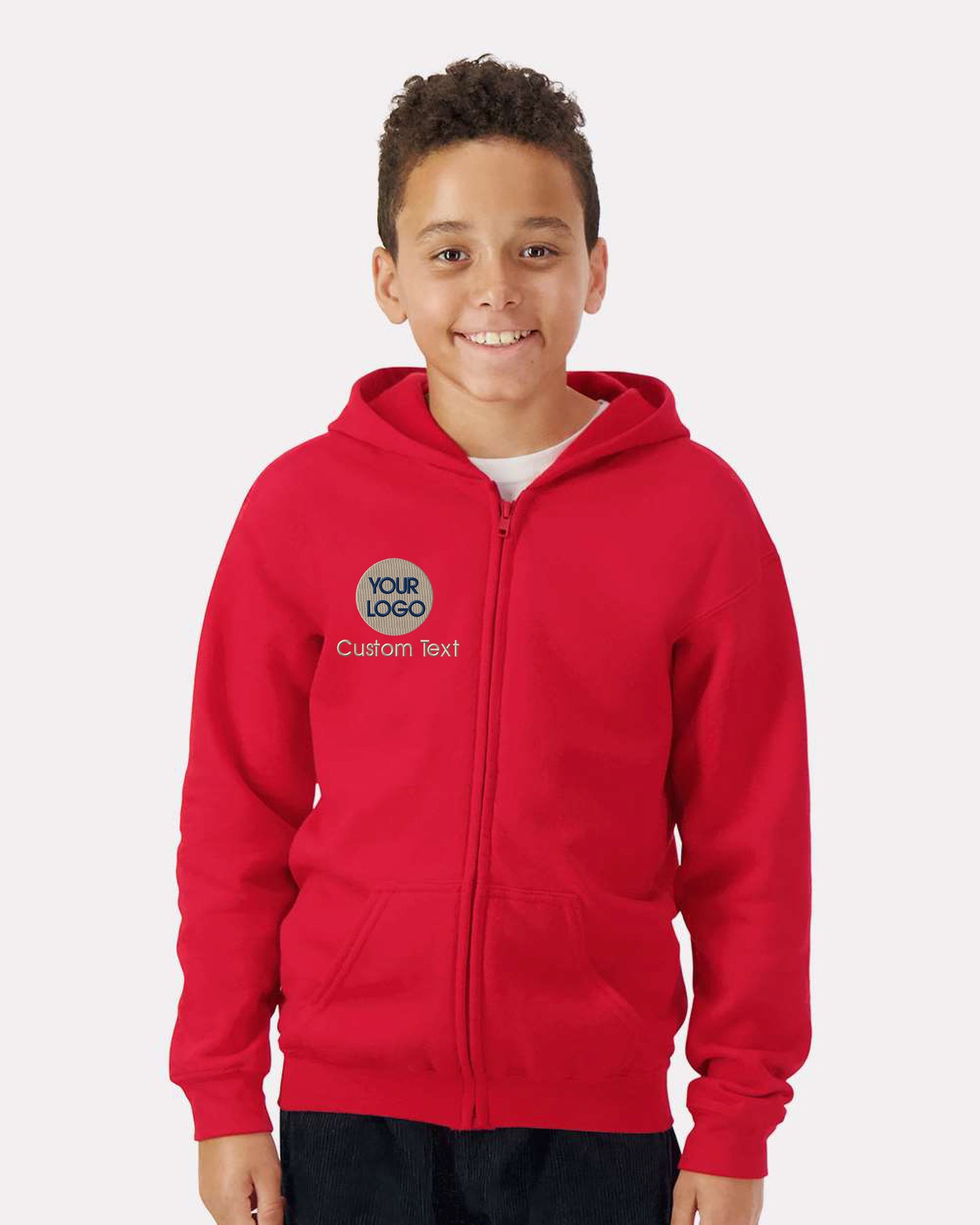 a young boy wearing a red hoodie with a green and white logo