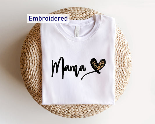 a white t - shirt with the word mama printed on it