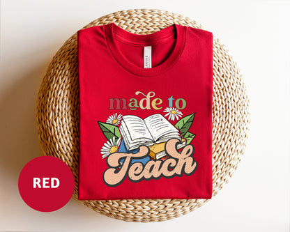 a red t - shirt with the words made to teach printed on it