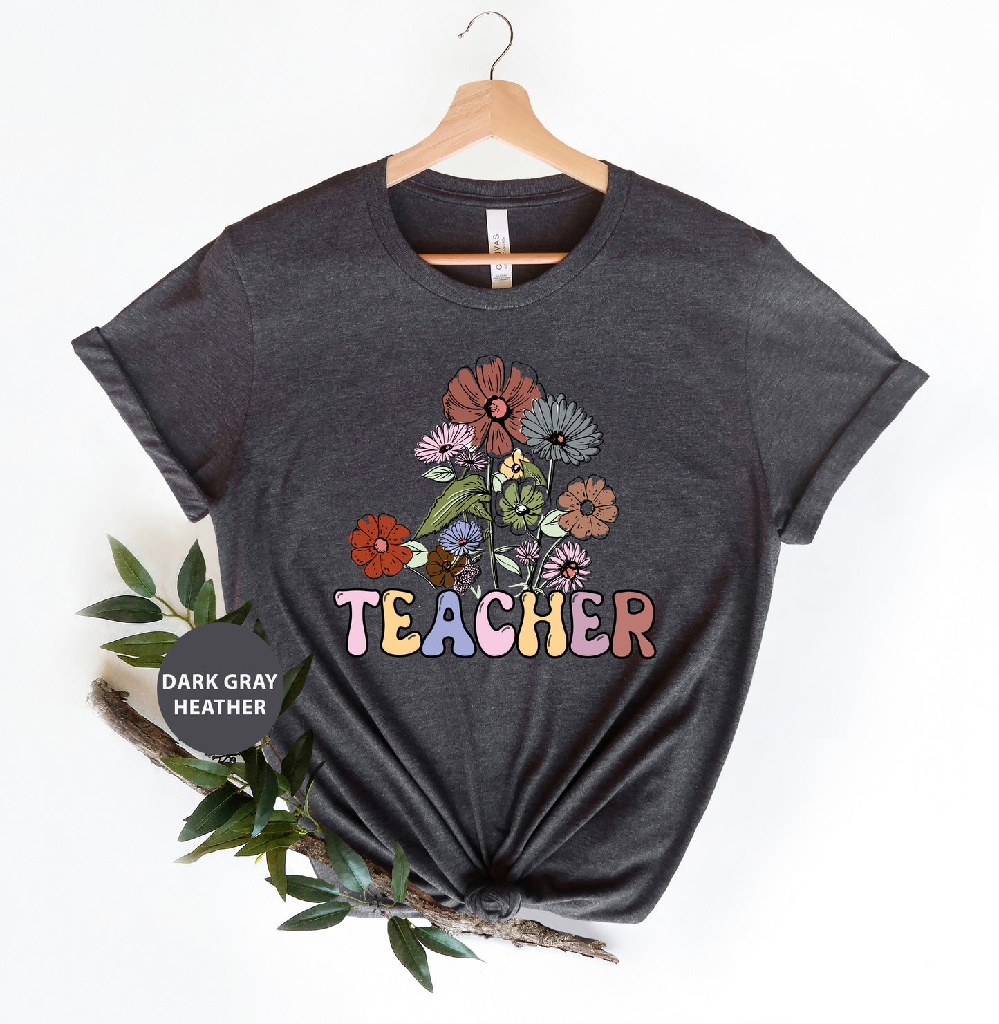 a t - shirt that says teacher with flowers on it