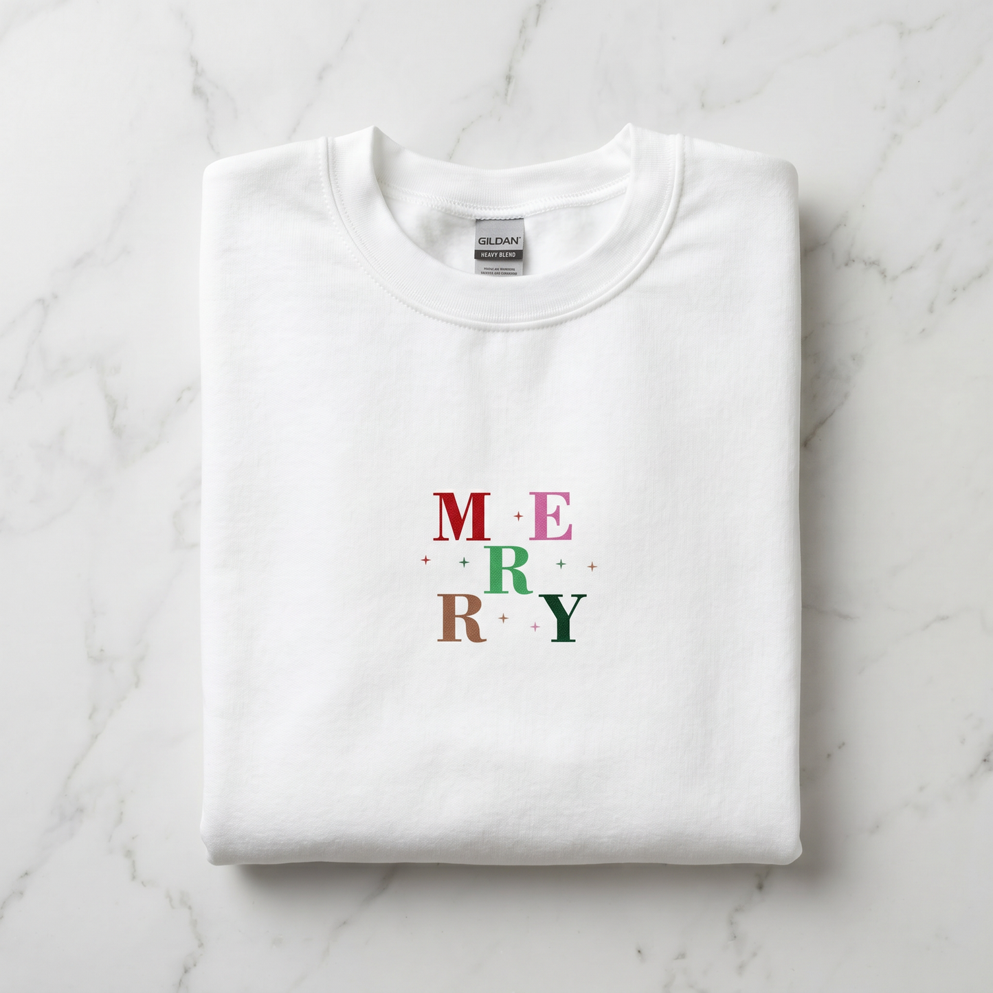 A white t-shirt with the word "MERRY" printed on it in a colorful design.