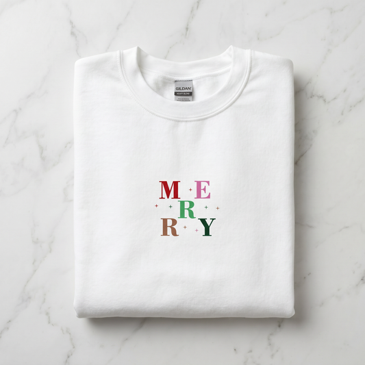 A white t-shirt with the word "MERRY" printed on it in a colorful design.