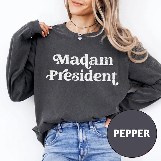 a woman wearing a sweatshirt that says madam president