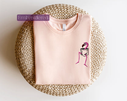 a pink t - shirt with a pink flamingo embroidered on it