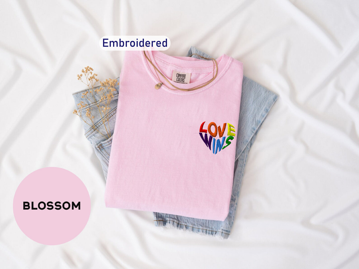 a pink shirt with the word love on it next to a pair of jeans