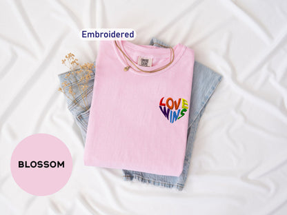 a pink shirt with the word love on it next to a pair of jeans