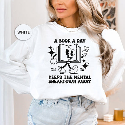 a woman wearing a book a day keeps the mental breakdown away sweatshirt