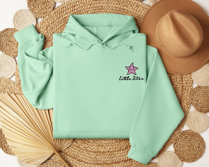 a green hoodie with a pink star on it