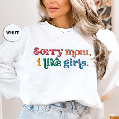 a woman wearing a white sweatshirt that says sorry mom, i like girls