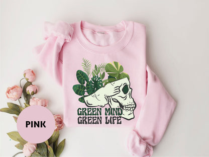 a pink sweater with a green mind on it