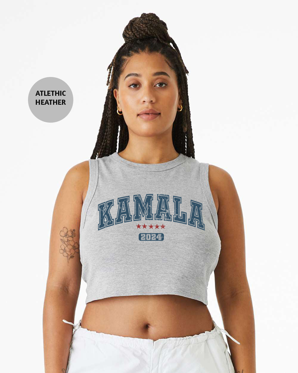 a woman wearing a crop top with the word kansas printed on it